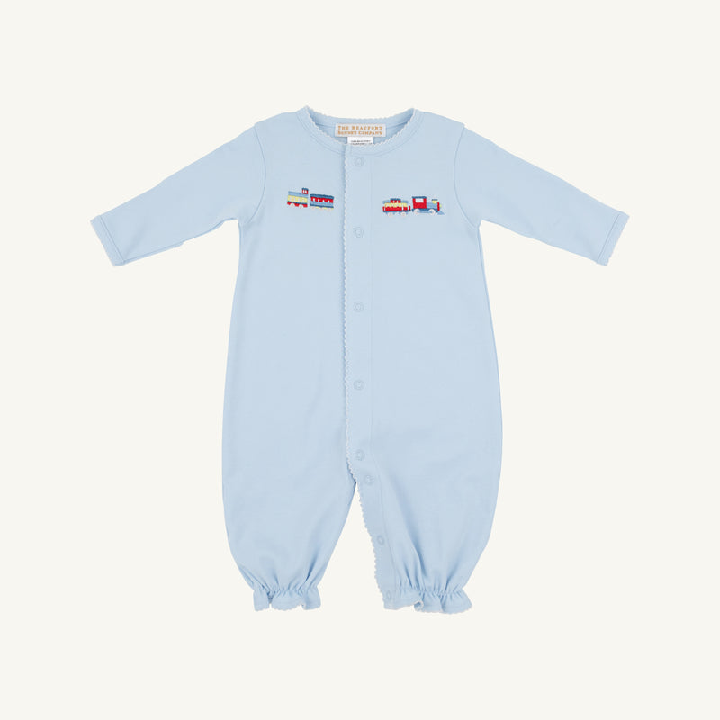 The Beaufort Bonnet Company’s Twinkle Twinkle 2-in-1 in Buckhead Blue with Trains is a light blue Pima cotton romper featuring long sleeves and legs, easy front snaps, and a vibrant embroidered train with colorful cargo cars across the chest. Gently gathered cuffs at the sleeves and ankles add to its soft, comfortable look.