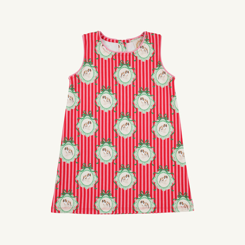 The Annie Apron Dress - Distinguished Doggies with Hamptons Hot Pink is a sleeveless A-line dress in red and white vertical stripes, featuring a repeating print of puppies inside scalloped, green-bowed frames.