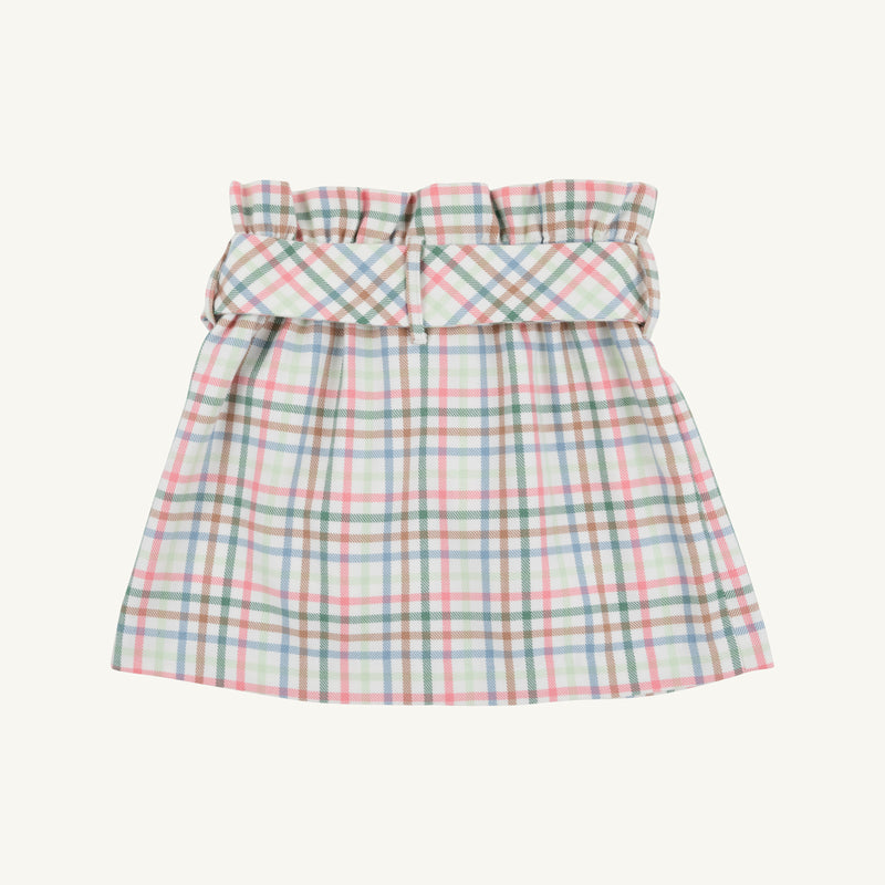 The Beasley Bow Skirt - Manalapan Plaid by The Beaufort Bonnet Company is a pastel plaid skirt featuring a gathered, ruffled waistband and a wide matching belt. Showcasing the signature Manalapan Plaid pattern for a light, summery look, this piece is presented on a plain, off-white background.