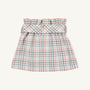 The Beasley Bow Skirt - Manalapan Plaid by The Beaufort Bonnet Company is a pastel plaid skirt featuring a gathered, ruffled waistband and a wide matching belt. Showcasing the signature Manalapan Plaid pattern for a light, summery look, this piece is presented on a plain, off-white background.