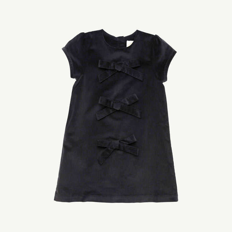 A short-sleeved, dark navy Betts Bow Dress - Newport Night Velveteen featuring three horizontal velvet bows down the center front.