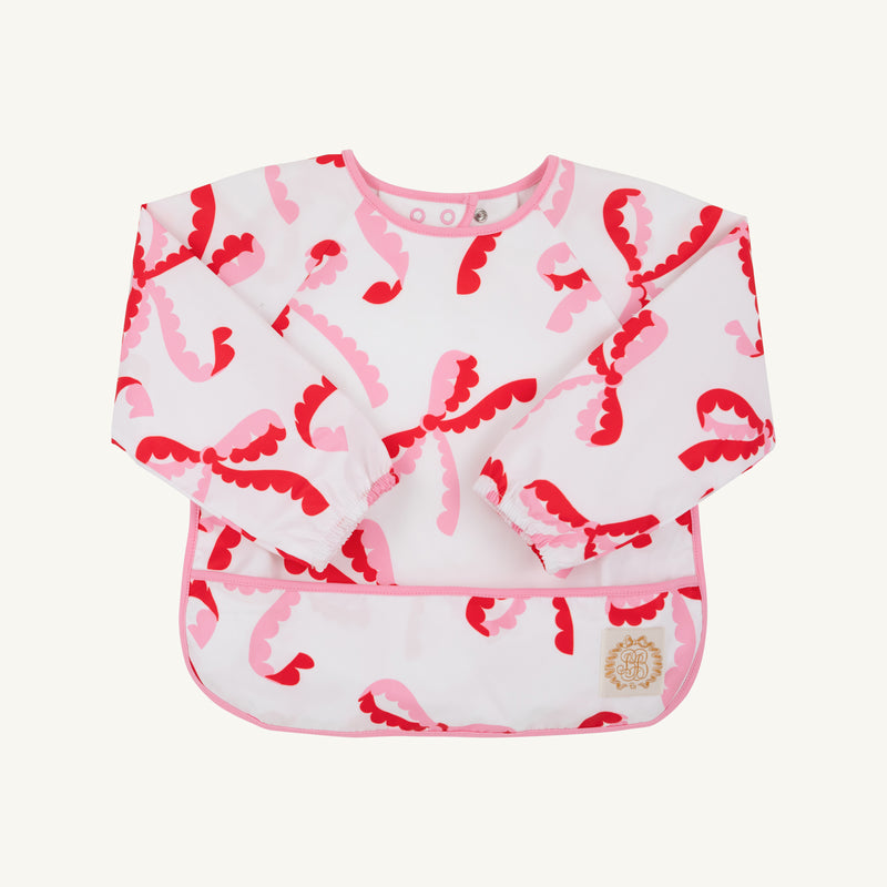 Long-sleeved Biscuit Bib - Bonnie Scot Bows with Hamptons Hot Pink, featuring a pink and red bow pattern with pink trim.