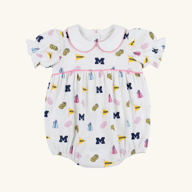 Dress your little one in The Beaufort Bonnet Company’s Michigan Britt Bubble – Bold in Blue with Hamptons Hot Pink. This white baby romper features charming puff sleeves, a Peter Pan collar, and pink trim. The playful pattern showcases blue M logos, yellow flags, blue and pink pom-poms, and megaphones. Made from soft Pima Cotton Knit with a gathered waist, it’s perfect for young fans who love to be bold in blue!.