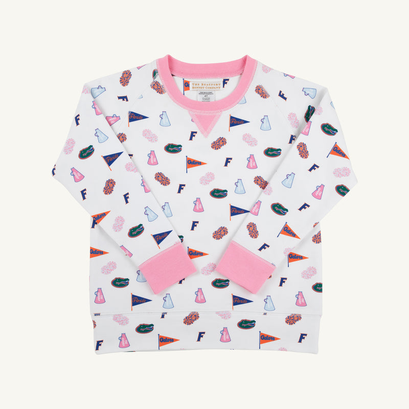 Introducing the Florida Cassidy Comfy Crewneck - Florida Forever with Hamptons Hot Pink by The Beaufort Bonnet Company. This children’s white sweatshirt features vibrant pink cuffs and collar, and a playful all-over print of pennants, “F” symbols, football helmets, and pom-poms—perfect for little University of Florida Gators fans. Cozy and spirited, this crewneck is the ultimate addition to any young fan’s gameday wardrobe.