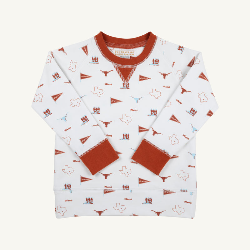 The Beaufort Bonnet Company’s Texas Cassidy Comfy Crewneck - Gone to Texas with Texas Orange is a white children’s sweatshirt featuring burnt orange cuffs, collar, and hem. It showcases playful Texas-themed icons—including state outlines, longhorns, pennants, and helmets in burnt orange and blue—making it the perfect cozy piece for displaying Lone Star State pride.