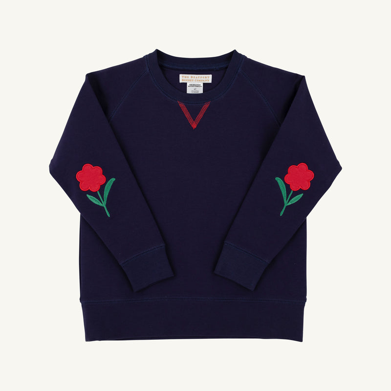 Navy blue Cassidy Comfy Crewneck - Nantucket Navy with Flowers featuring embroidered flower appliqués on each sleeve and red V-stitch detailing at the neckline.