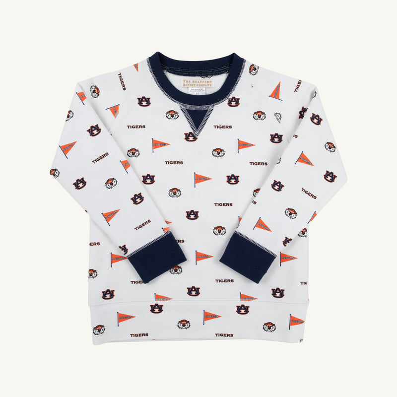 Dress your child in Auburn pride with the Auburn Cassidy Comfy Crewneck - Tiger Thrill with Auburn Blue by The Beaufort Bonnet Company. This cozy white sweatshirt features a navy blue collar and cuffs, and is playfully decorated with scattered Auburn University logos, tiger mascots, orange pennants, and the word “TIGERS” in an all-over pattern—perfect for showing off that true Auburn Blue spirit.