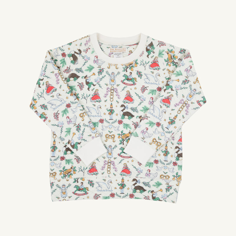 Cassidy Comfy Crewneck - 12 Days of Christmas by The Beaufort Bonnet Company is a long-sleeve children’s shirt featuring colorful holiday-themed illustrations—nutcrackers, reindeer, rocking horses, and trees—on a white background, making it the perfect festive top for holiday parties inspired by the classic “12 Days of Christmas.”.