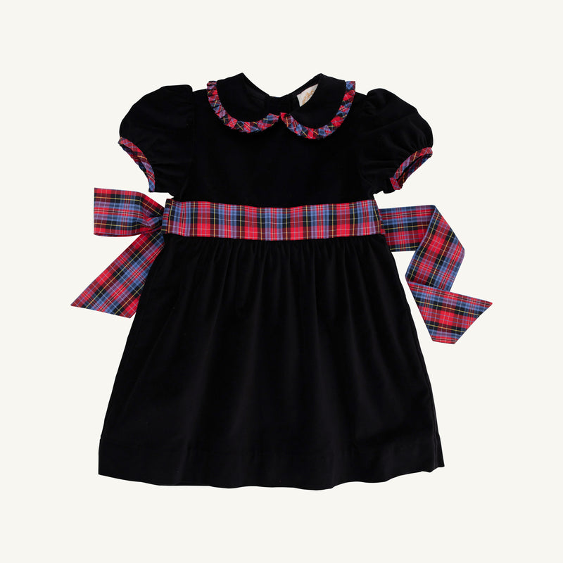 The Cindy Lou Sash Dress - Newport Night Velveteen with Bucktown Tartan by The Beaufort Bonnet Company is a delightful holiday dress for girls, crafted from soft velveteen and adorned with puffed short sleeves, a scalloped collar, and a large red, blue, and green Bucktown Tartan sash tied in a bow at the back—perfect for festive celebrations.