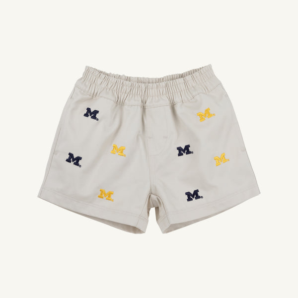 Introducing the Michigan Critter Sheffield Shorts in Saratoga Stone by The Beaufort Bonnet Company. These light beige shorts feature an elastic waistband and are adorned with embroidered blue and yellow Michigan logos throughout, combining comfort with spirited University of Michigan style.