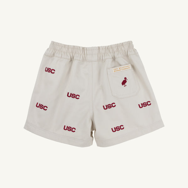 Show your Gamecock pride with the South Carolina Critter Sheffield Shorts in Saratoga Stone by The Beaufort Bonnet Company. These beige shorts feature an elastic waistband, multiple embroidered USC logos in red, and a small red bird on the back pocket—making them stadium-ready and perfect for true fans.