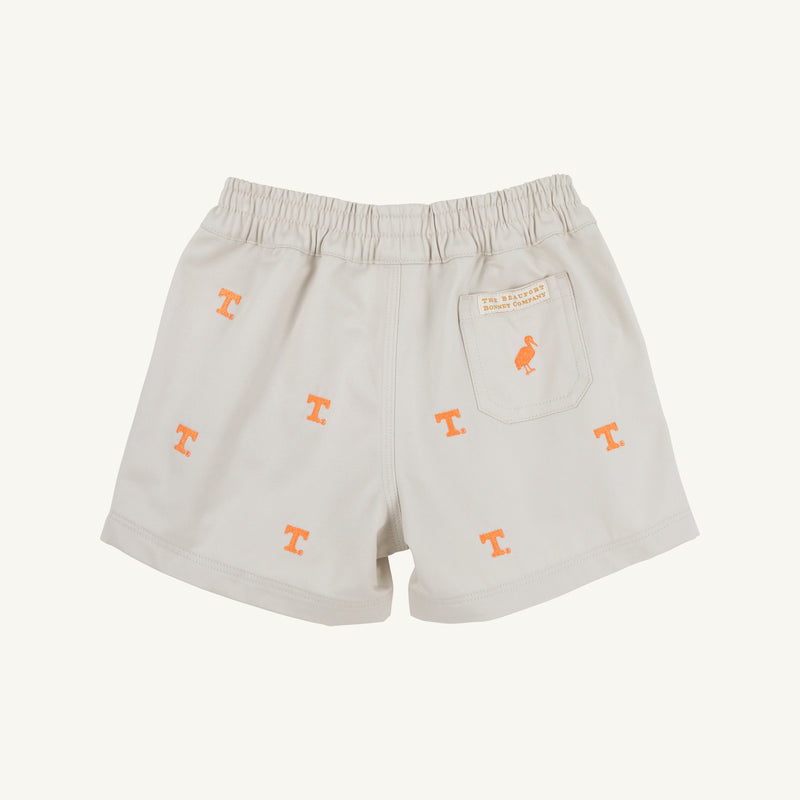 The Beaufort Bonnet Company’s Tennessee Critter Sheffield Shorts in Saratoga Stone feature an elastic waistband, orange T logo embroidery, and a back pocket detailed with a small orange bird and stitched label. Crafted from 100% cotton, these light-colored shorts are shown laying flat on a neutral background.