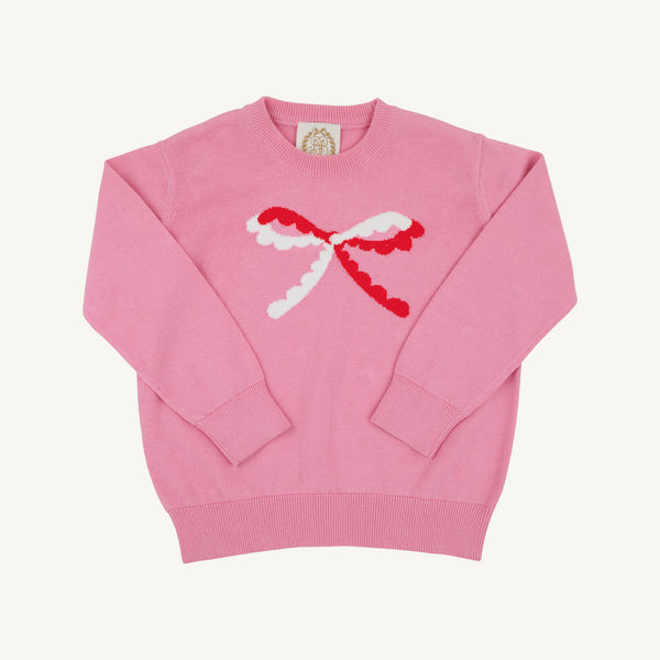 Isabelle’s Intarsia Sweater in Hamptons Hot Pink with a long-sleeved design, featuring a white and red scalloped bow on the front.