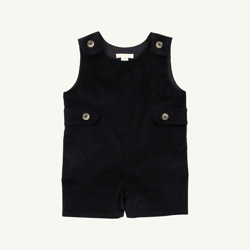 The Jack Keene Jon Jon - Newport Night Corduroy by The Beaufort Bonnet Company is a sleeveless toddler romper made from soft corduroy, featuring buttons on the shoulders and sides, plus two flap accents at the waist. Its cozy feel makes it a perfect holiday outfit, shown against a plain white background.