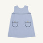 The Jill Jumper - Park City Periwinkle Stripe with Nantucket Navy is a light blue and white sleeveless piece featuring two patch pockets with dark navy trim and a gold button on each pocket.