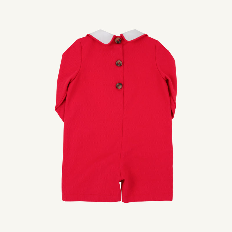 A John Hall Jon Jon in Richmond Red Pique with Worth Avenue White trim by The Beaufort Bonnet Company, featuring a white collar and three brown buttons down the back, displayed flat on a plain background. Perfect for a classic Christmas outfit.