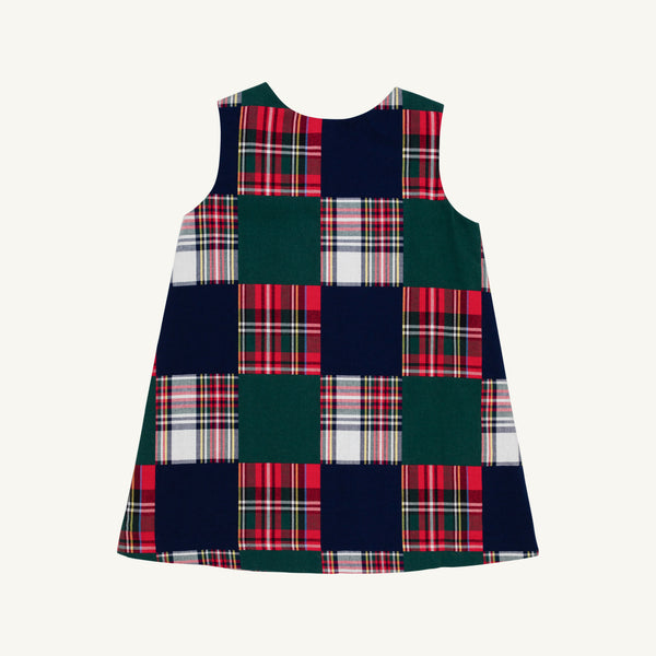 The Beaufort Bonnet Company Juliet Jumper - Mercer Island Madras is a sleeveless A-line jumper featuring a checkerboard pattern of solid dark green and red-and-white plaid squares.