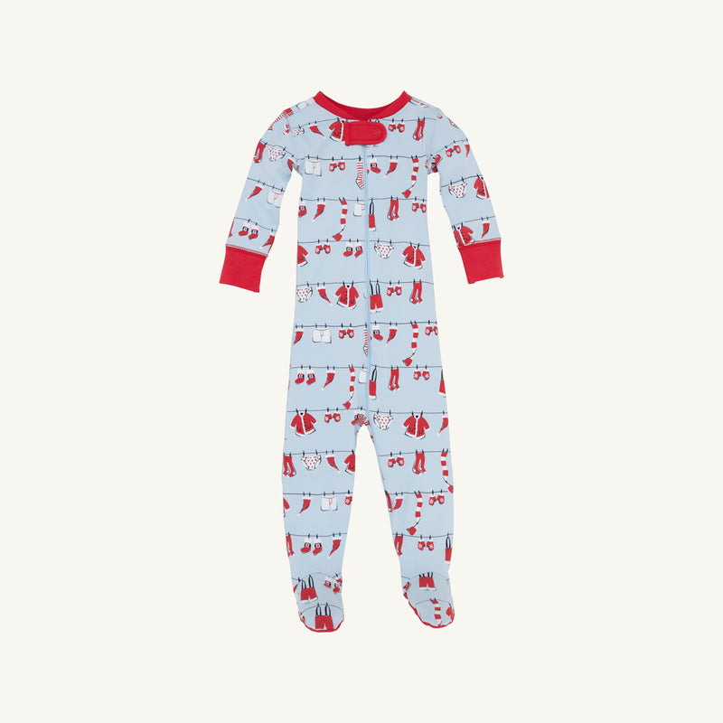 Introducing the Knox’s Night Night - Santa’s Laundry Line by The Beaufort Bonnet Company: a soft Pima cotton footed baby onesie in light blue, adorned with red cuffs and a whimsical print of red and white holiday clothes and accessories hanging on clotheslines. Perfect for family matching pajamas during the holiday season.