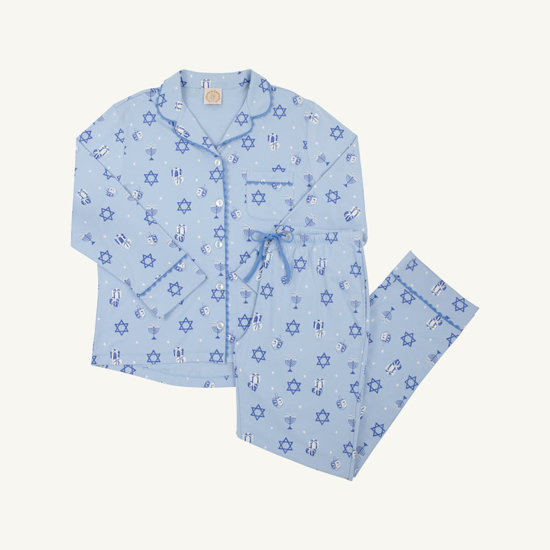 The Let Me Lounge Set - Eight Nights to Remember with Barbados Blue by The Beaufort Bonnet Company is a light blue Hanukkah pajama set featuring a button-up top and pants adorned with blue Stars of David, menorahs, dreidels, and wine glasses, displayed on a white background. Perfect for family matching pajamas or relaxing in this cozy Pima cotton lounge set.