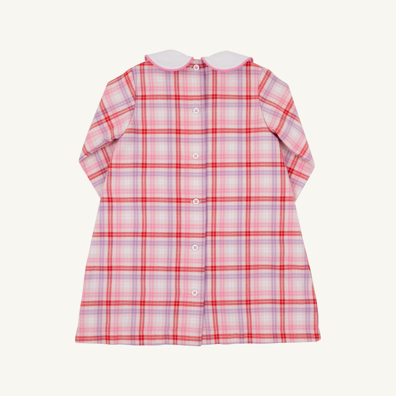 Back view of a Lindy’s Lunch Dress - Broadway Play Plaid with Worth Avenue White, a long-sleeved plaid holiday dress in shades of pink, red, and white, featuring a white rounded collar and a vertical row of buttons down the back.