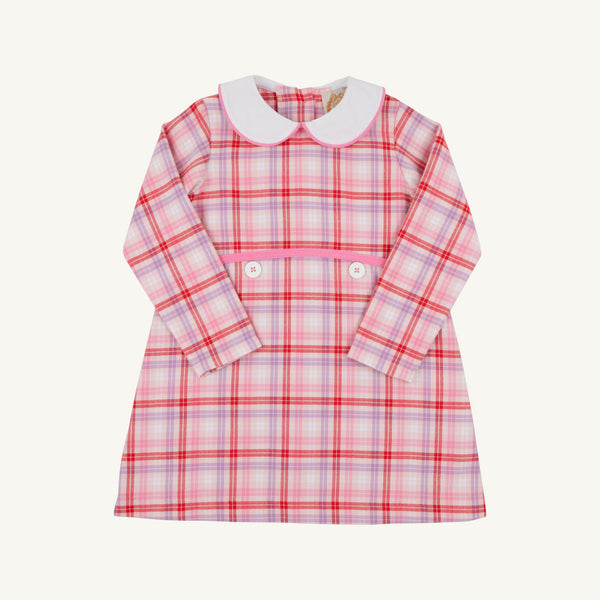 The Beaufort Bonnet Company Lindy’s Lunch Dress - Broadway Play Plaid with Worth Avenue White is a long-sleeved pink and purple plaid holiday dress with a white rounded collar and two white buttons at the waist.