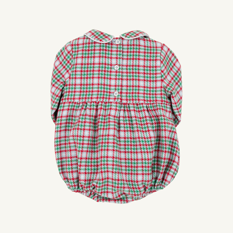 The Beaufort Bonnet Company’s Long Sleeve Bradford Bubble in Wicker Park Plaid with Worth Avenue White features a classic red, green, and white plaid pattern, a Peter Pan collar, long sleeves, back button closure, and elastic leg openings—making it the perfect festive holiday outfit or timeless romper for baby boys.