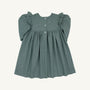 The Long Sleeve Daphne Dress - Grier Green Herringbone by The Beaufort Bonnet Company is shown laid flat on a light background. This dress features a muted green herringbone pattern, puffed long sleeves, ruffle detailing at the shoulders, a gathered skirt, and three buttons down the front.