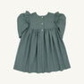 The Long Sleeve Daphne Dress - Grier Green Herringbone by The Beaufort Bonnet Company is shown laid flat on a light background. This dress features a muted green herringbone pattern, puffed long sleeves, ruffle detailing at the shoulders, a gathered skirt, and three buttons down the front.