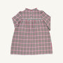 A Long Sleeve Mary Baker Day Dress in Wicker Park Plaid with Richmond Red by The Beaufort Bonnet Company, featuring a ruffled collar and buttons on the upper chest, is displayed on a plain background.