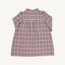 A Long Sleeve Mary Baker Day Dress in Wicker Park Plaid with Richmond Red by The Beaufort Bonnet Company, featuring a ruffled collar and buttons on the upper chest, is displayed on a plain background.