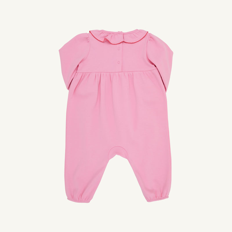 The Long Sleeve Ramona Ruffle Romper - Hamptons Hot Pink with Wreath Embroidery by The Beaufort Bonnet Company is crafted from soft Pima Cotton and features a charming scalloped collar, button details on the chest, and gathered fabric at the waist. Designed for comfort with elastic hems at the legs and wrists, this festive romper makes a perfect holiday outfit and is shown laid flat on a light background.