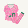 The Beaufort Bonnet Company’s Long Sleeve Stay in Bed Set - Bows of Holly with Kiawah Kelly Green features a cheerful pink pajama set adorned with white floral “bows of holly” and green leaves, complemented by Kiawah Kelly Green trim on the neckline and waistband, plus a matching green waist tie. This festive holiday pajama set includes a long-sleeve top and full-length pants, making it perfect for cozy Christmas mornings or matching family pajamas.