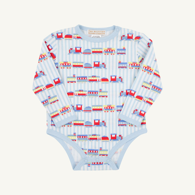 The Beaufort Bonnet Company’s Long Sleeve Walt Onesie - Choo Choo Coming Through with Buckhead Blue is a soft Pima cotton baby bodysuit, designed in a light blue shade and decorated with playful train and track motifs along vertical stripes, shown laid flat on a white background.