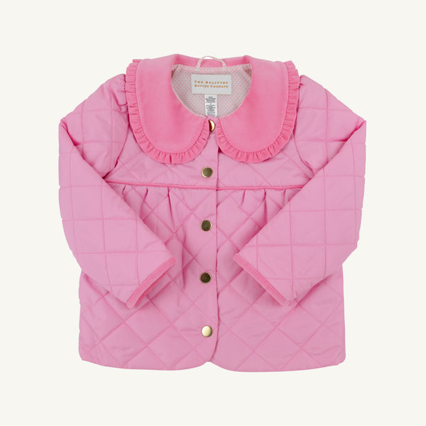 Maude’s Carlyle Quilted Coat in Hamptons Hot Pink with Palm Beach Pink is a bright hot pink quilted coat with a rounded collar, ruffled trim, and gold-tone buttons.