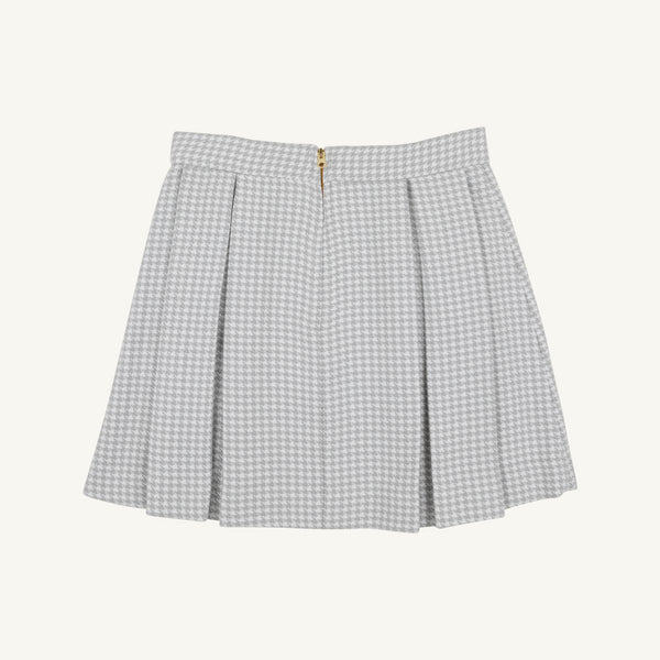 Parson Pleated Skirt - Grantley Gray Houndstooth featuring a gray and white houndstooth pattern, pleated design, and a gold back zipper.