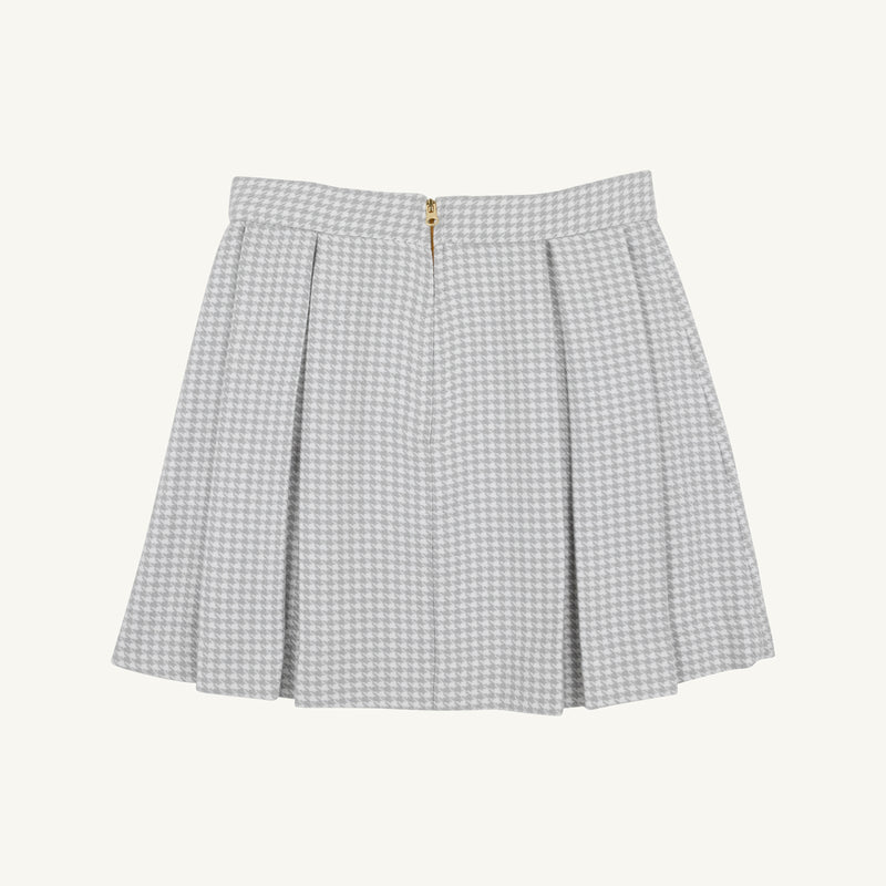 Parson Pleated Skirt - Grantley Gray Houndstooth featuring a gray and white houndstooth pattern, pleated design, and a gold back zipper.
