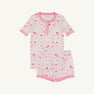 The Beaufort Bonnet Company’s Payton Pajama Shorts Set – Ice Cream Daydream (Strawberry Pink) features a soft cotton jersey children’s pajama set with short sleeves, pink trim, and a delightful dessert-inspired print of cakes, cherries, and ice cream on a white background. This comfy set includes a matching top and shorts for cozy bedtime style.