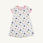 The Beaufort Bonnet Company’s Michigan Polly Play Dress - Bold in Blue with Hamptons Hot Pink features a white short-sleeve design trimmed in pink and decorated with University of Michigan M logos, yellow pennants, pom-poms, and megaphones. Made from 100% Pima Cotton for ultimate comfort, it’s perfect for showing your Bold in Blue spirit!.