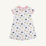 The Beaufort Bonnet Company’s Michigan Polly Play Dress - Bold in Blue with Hamptons Hot Pink features a white short-sleeve design trimmed in pink and decorated with University of Michigan M logos, yellow pennants, pom-poms, and megaphones. Made from 100% Pima Cotton for ultimate comfort, it’s perfect for showing your Bold in Blue spirit!.