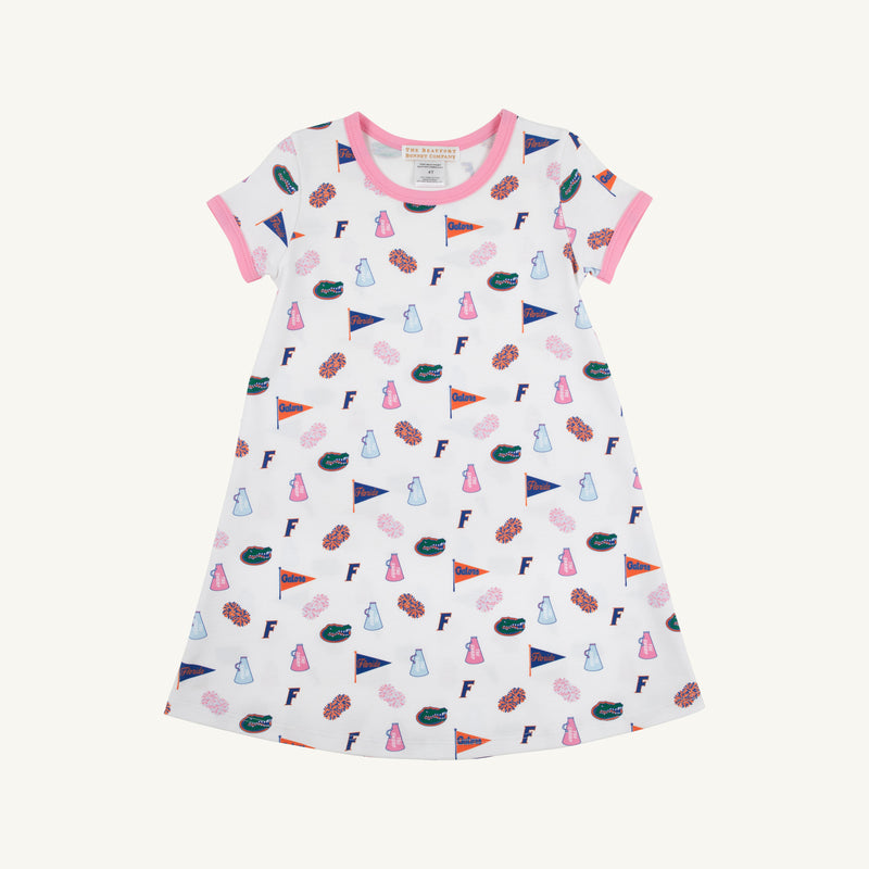 Introducing the Florida Polly Play Dress - Florida Forever with Hamptons Hot Pink by The Beaufort Bonnet Company, a white short-sleeve dress accented with vibrant pink trim. Adorned with a cheerful Florida Forever print featuring lab flasks, flags, donuts, the letter F, and brains arranged in a playful design. Made from soft Pima Cotton Knit for all-day comfort.
