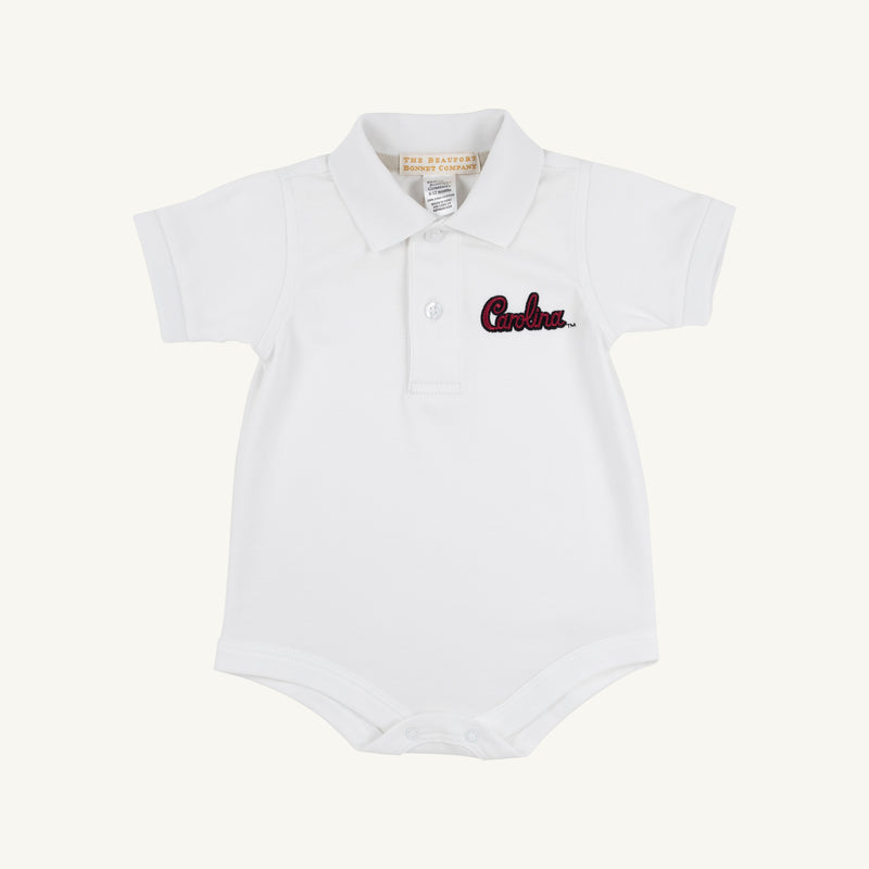 South Carolina Prim & Proper Polo in Worth Avenue White by The Beaufort Bonnet Company—crafted from soft Pima Cotton Knit, this white baby onesie features a collar, buttons, and “Carolina” embroidered in red on the left chest.