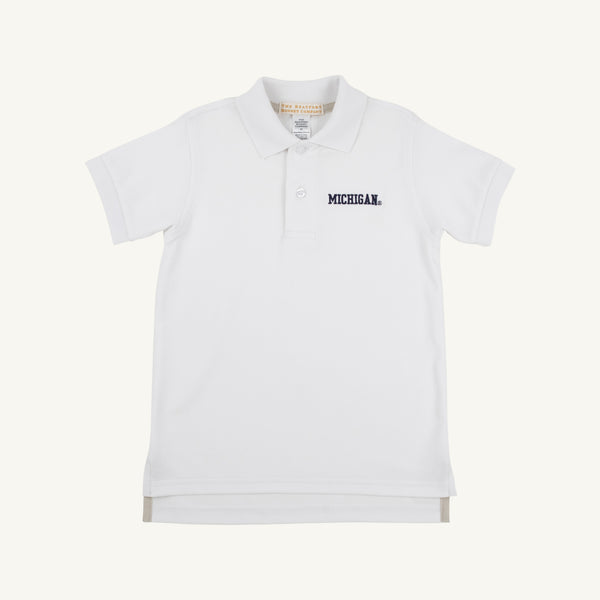 Introducing the Michigan Prim & Proper Polo - Worth Avenue White by The Beaufort Bonnet Company. This classic short-sleeve polo is made from soft Pima Cotton Knit and features a collared neckline with buttons. “MICHIGAN” is embroidered in navy blue on the left chest, showcasing your school pride with timeless style.