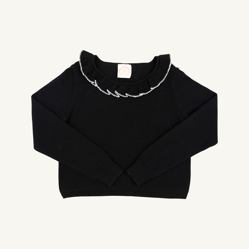The Beaufort Bonnet Company’s Reece Ruffle Sweater - Newport Night with Palmetto Pearl is a long-sleeve holiday sweater featuring a charming ruffled collar and white decorative stitching along the neckline, displayed flat against a plain white background. Made from 100% cotton for both comfort and style.