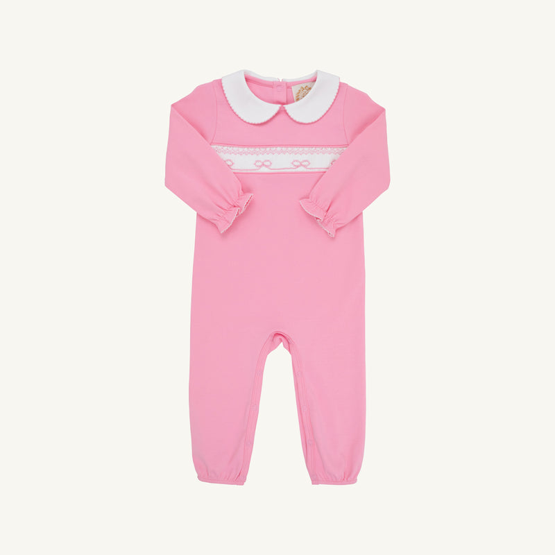 The Beaufort Bonnet Company Rigsby Romper - Hamptons Hot Pink with Worth Avenue White and Bow Smocking featuring a white Peter Pan collar and white bow smocking across the chest.