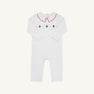 The Samuel Smocked Romper - Worth Avenue White & Richmond Red with Trees is a white long-sleeved Pima cotton romper with a red-trimmed collar and a smocked chest panel featuring green Christmas trees and red dots.