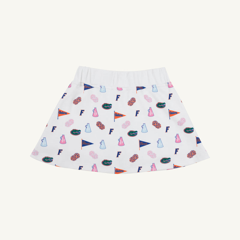 The Beaufort Bonnet Company’s Florida Searcy Skort – Florida Forever with Worth Avenue White features a soft Pima Cotton Knit fabric and a comfortable elastic waistband. The skort showcases a vibrant pattern of colorful University of Florida motifs—including pennants, F logos, cheer megaphones, and gator mascots—set against a crisp white background in the signature Florida Forever print.
