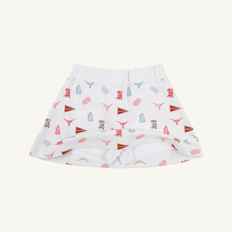 The Texas Searcy Skort - Gone to Texas with Worth Avenue White by The Beaufort Bonnet Company is laid flat on a white background, featuring playful red, blue, and pink motifs—including longhorns, pennants, vases, and flowers—from the signature Gone to Texas print.