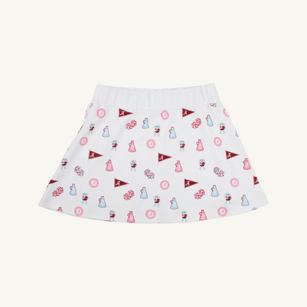 The Alabama Searcy Skort by The Beaufort Bonnet Company in Sweet Home Honey with Worth Avenue White features a playful pattern of maroon pennants, pink pom-poms, small cheerleader icons, and megaphones scattered across its soft Pima Cotton Knit fabric.