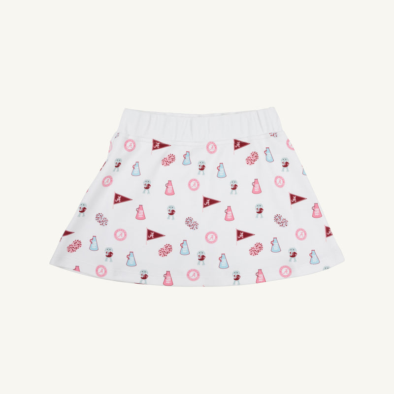 The Alabama Searcy Skort by The Beaufort Bonnet Company in Sweet Home Honey with Worth Avenue White features a playful pattern of maroon pennants, pink pom-poms, small cheerleader icons, and megaphones scattered across its soft Pima Cotton Knit fabric.