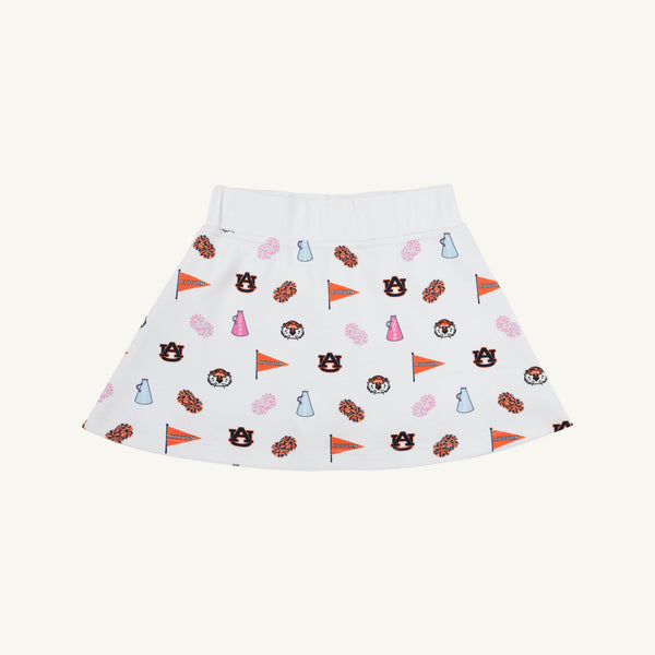 The Beaufort Bonnet Company’s Auburn Searcy Skort - Tiger Thrill with Worth Avenue White features lively Auburn University-themed prints, including logos, tiger mascots, megaphones, pom-poms, and pennants in vibrant orange, navy, pink, and blue hues. This playful skort is perfect for a spirited gameday outfit and is shown here on a neutral background.